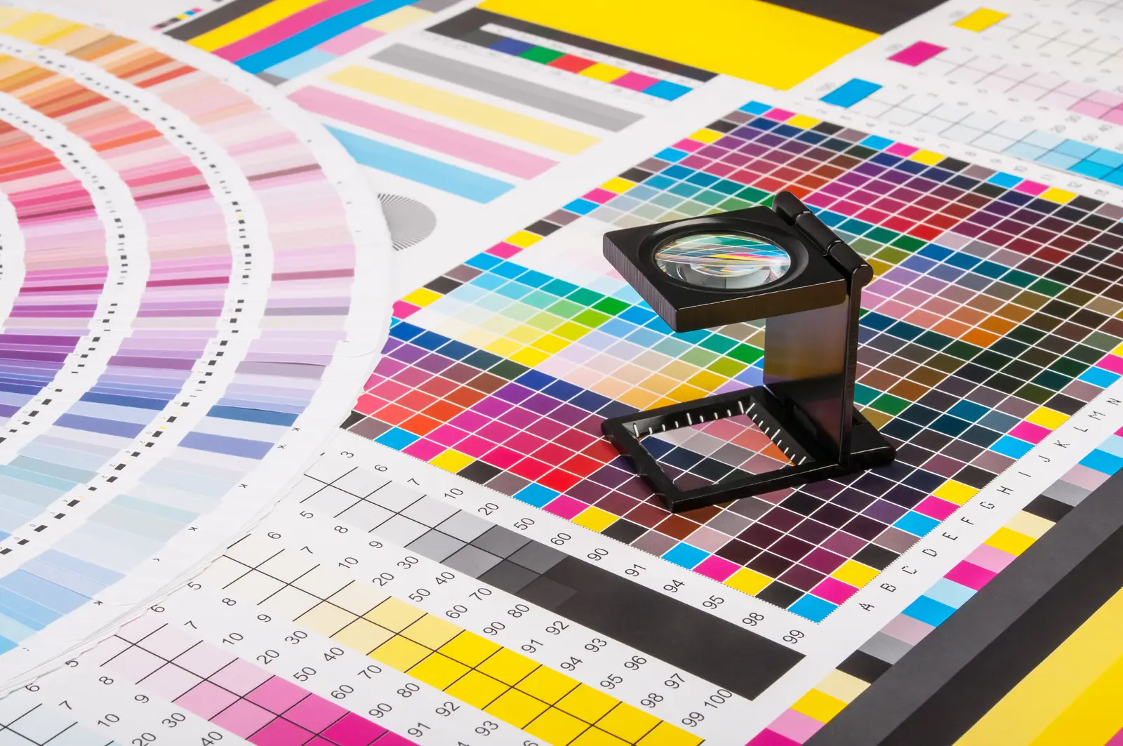 Colour check with a loupe on a printed sheet