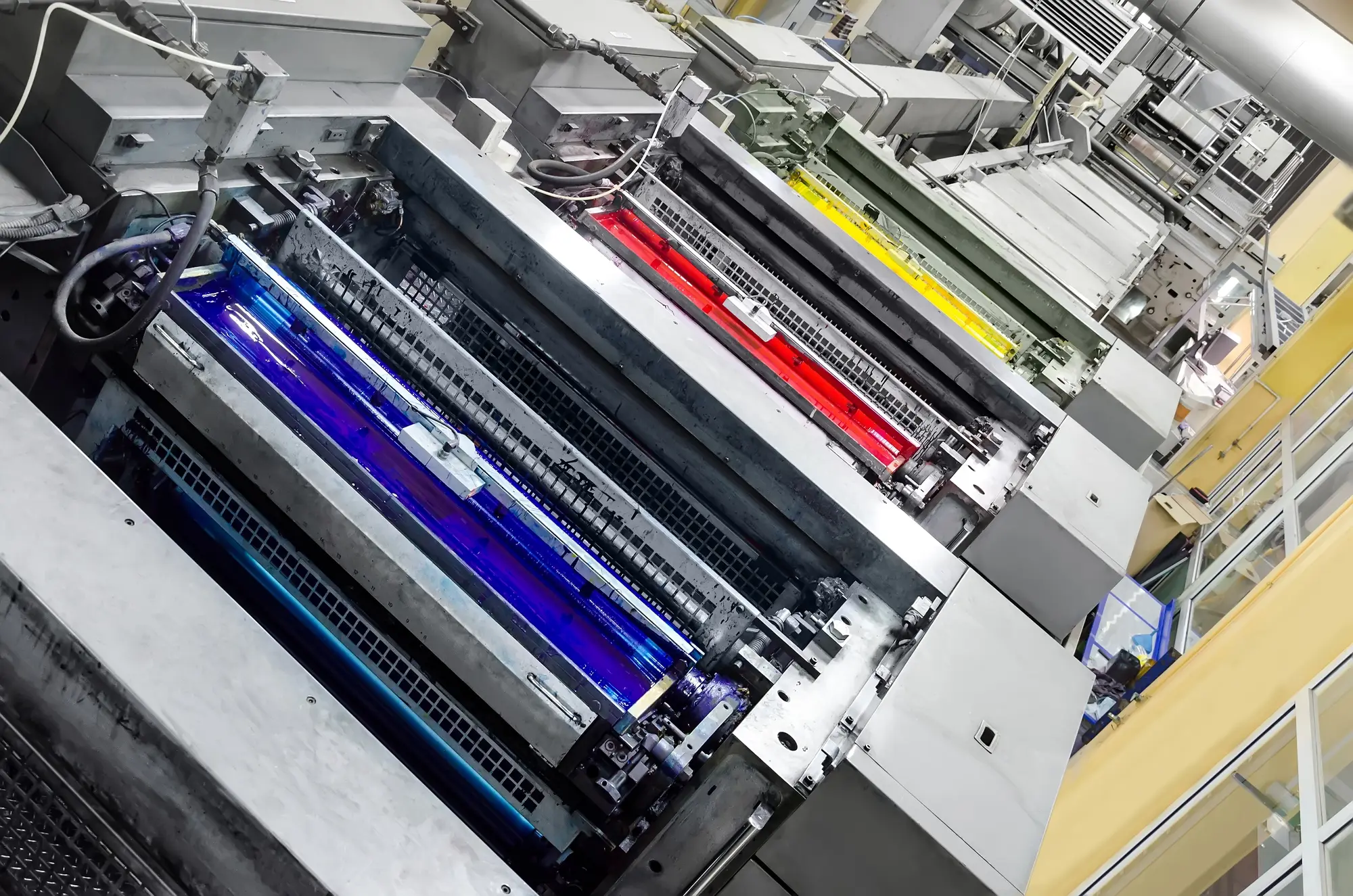 Roland offset printing press with cyan, magenta and yellow colour units